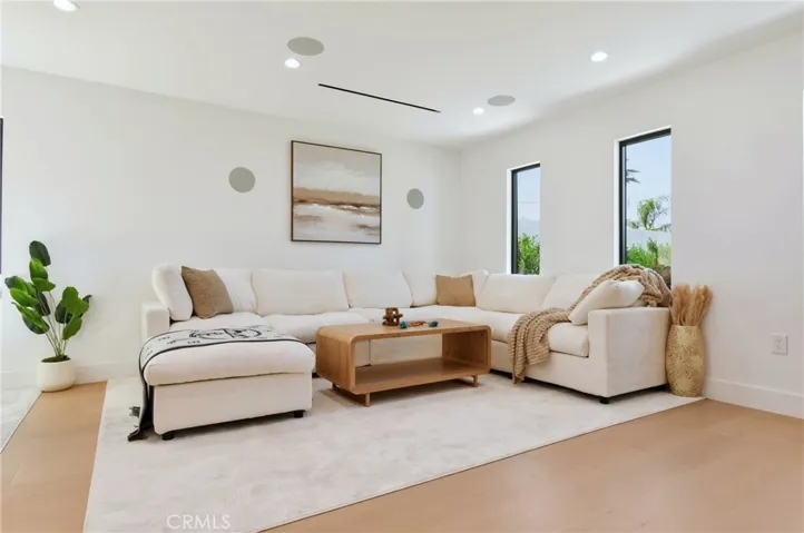 Bright, wide-angle view of the family room highlighting its direct access to the rest of the home.
