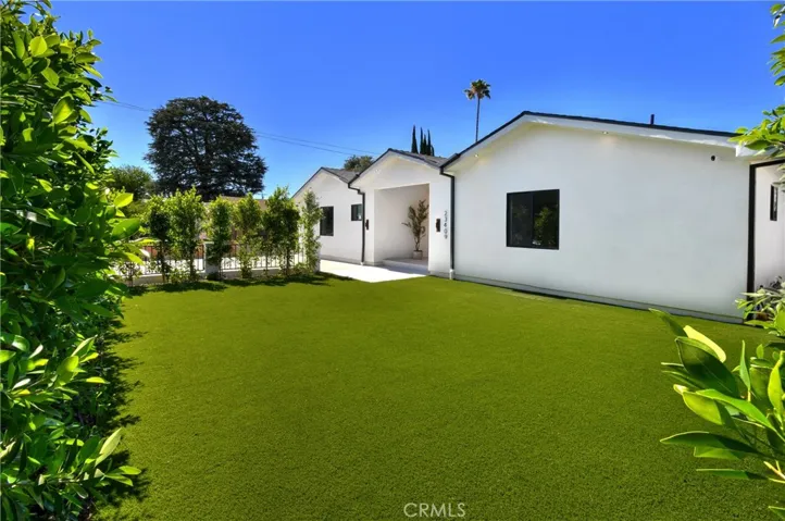 Charming and beautifully maintained single-story residence, featuring a lush front lawn and exceptional curb appeal