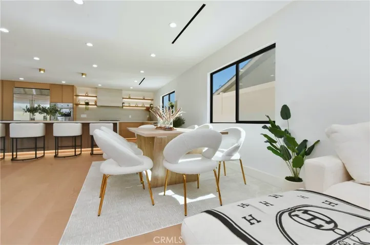 Seamless open-concept flow connecting the dining space, kitchen, and secondary living areas