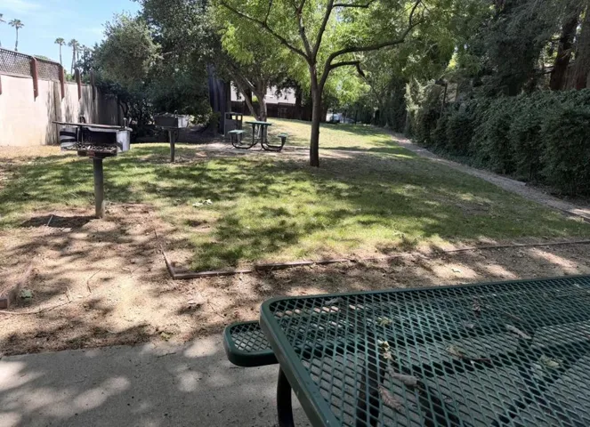Private community green space with BBQ pits and picnic benches.
