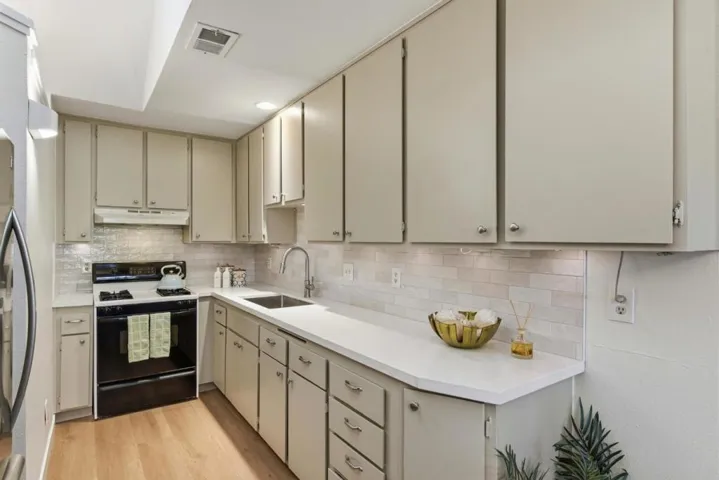 Remodeled kitchen with new quarts, new subway backsplash and fresh paint.