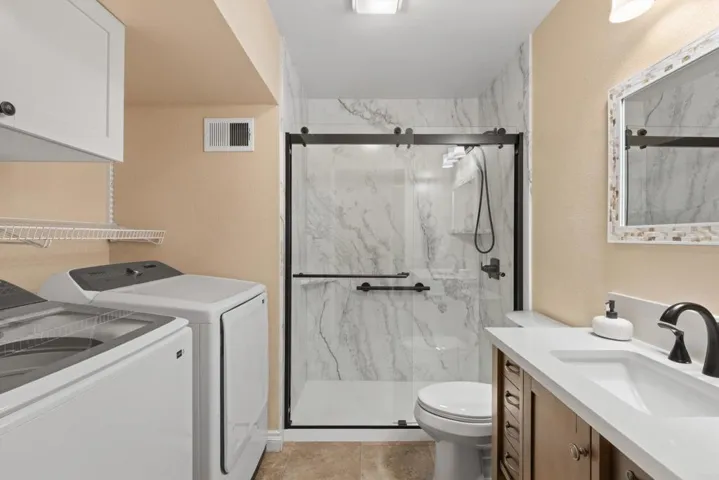 Downstairs bathroom including laundry. Fully updated with new vanity and walk-in shower.
