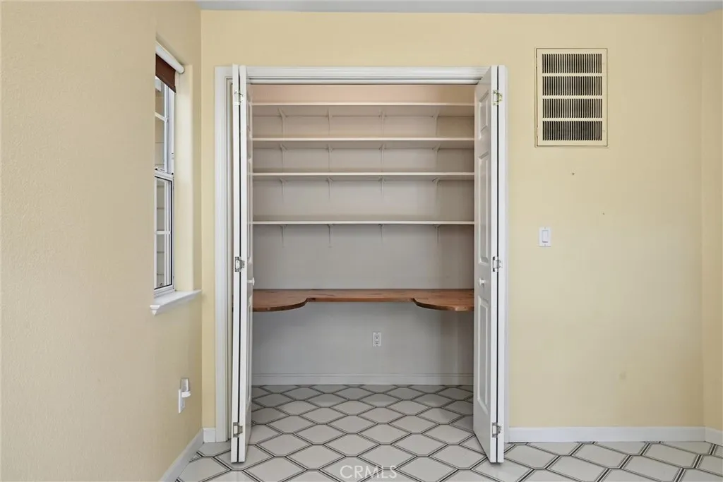 This smart closet could be useful for so many reasons......tile floor, 1/2 bathroom and door leading to the garage is just steps away.  Not every kitchen design remembers the relationship between the car and the kitchen when you have returned from shopping..........this is area is very well designed.