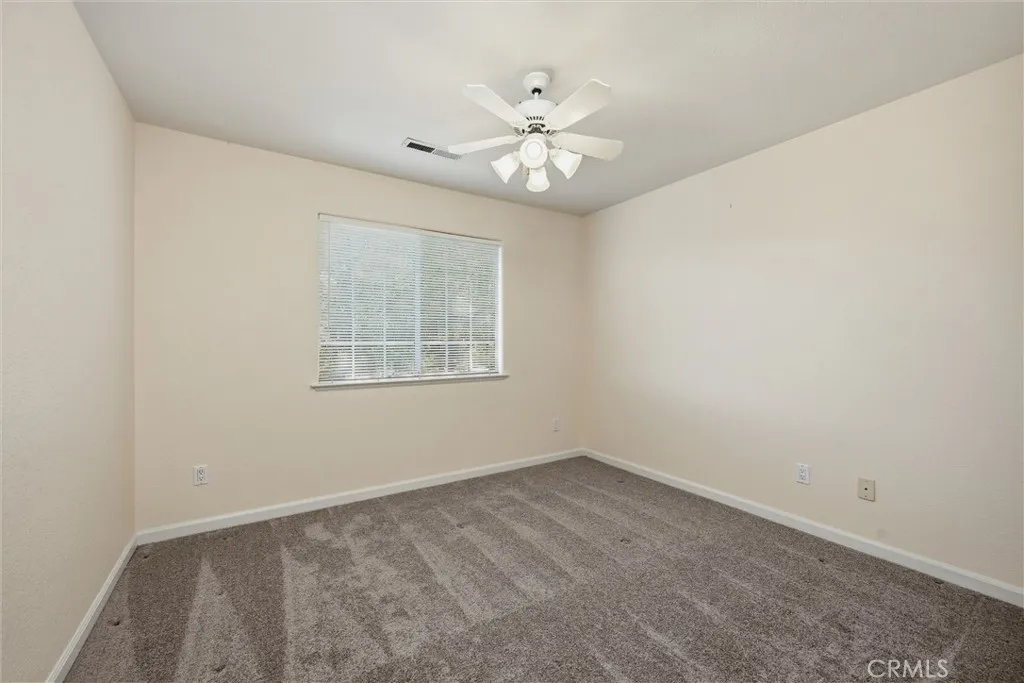 Upstairs bedroom with spacious closet and ceiling fan