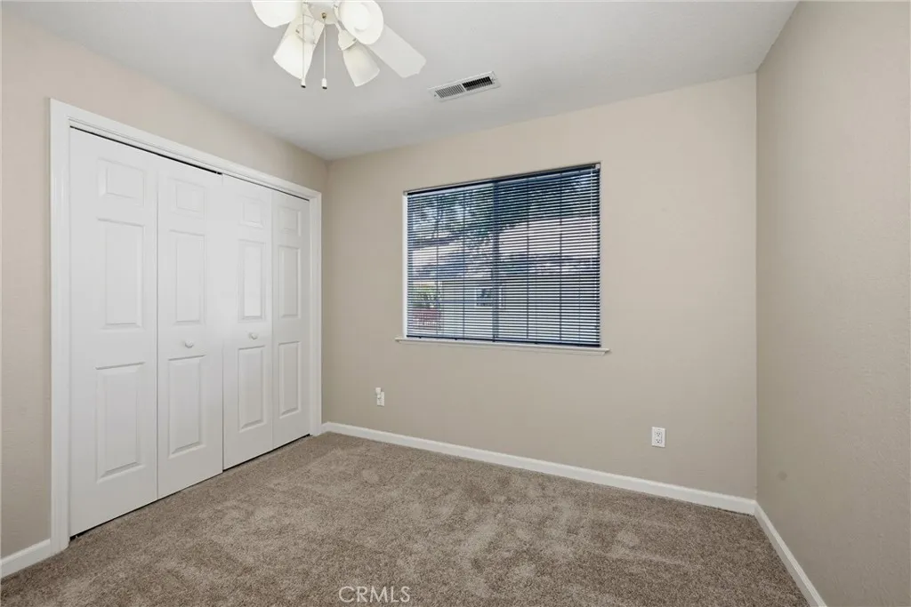 2nd of three bedrooms, spacious, neutral colored Mohawk carpet, spacious closet, ceiling fan, window with views