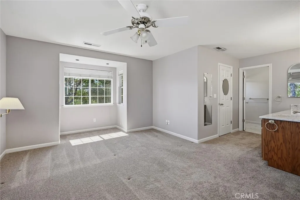 A cozy alcove, to the right is the luscious bath area; stunning counter tops and sink, opposite side is the closet door then entry into the bathroom and walk in shower, yummy