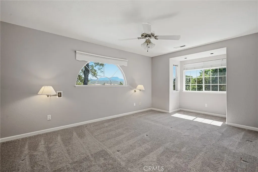 Relax in this spacious primary bedroom with alcove for that special reading chair.  Ceiling fan, lights for both sides of the bed, views...........pretty nice