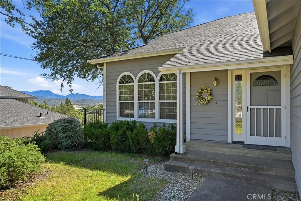 There is a pathway to the left of the house that goes down to an area under the deck that is built in front of the three windows;  It continues to the door along side of the home that leads to the underneath portion of the home, and then on to the covered area under the deck.  Lots of storage and easy access under the home.