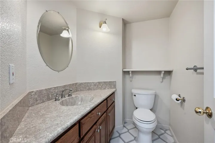 Downstairs half bath.........oak cabinets, tile floor low flow toilet