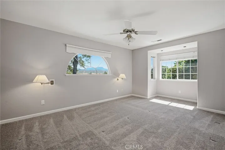 Relax in this spacious primary bedroom with alcove for that special reading chair.  Ceiling fan, lights for both sides of the bed, views...........pretty nice