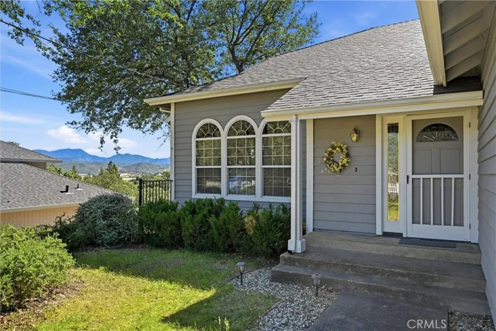 There is a pathway to the left of the house that goes down to an area under the deck that is built in front of the three windows;  It continues to the door along side of the home that leads to the underneath portion of the home, and then on to the covered area under the deck.  Lots of storage and easy access under the home.