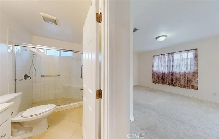 view of master bed and bath from living room