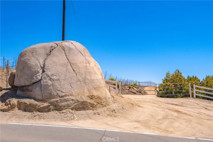 Huge boulder monument at the gated property entrance.