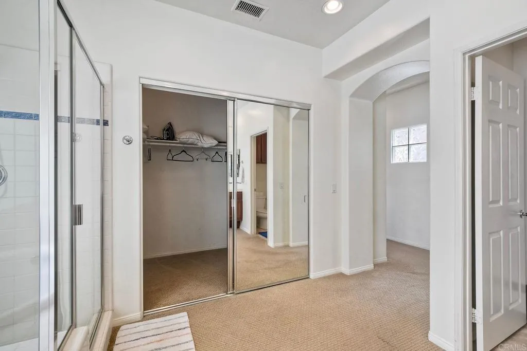 The primary suite features an enormous walk-in closet, offering abundant storage and organization