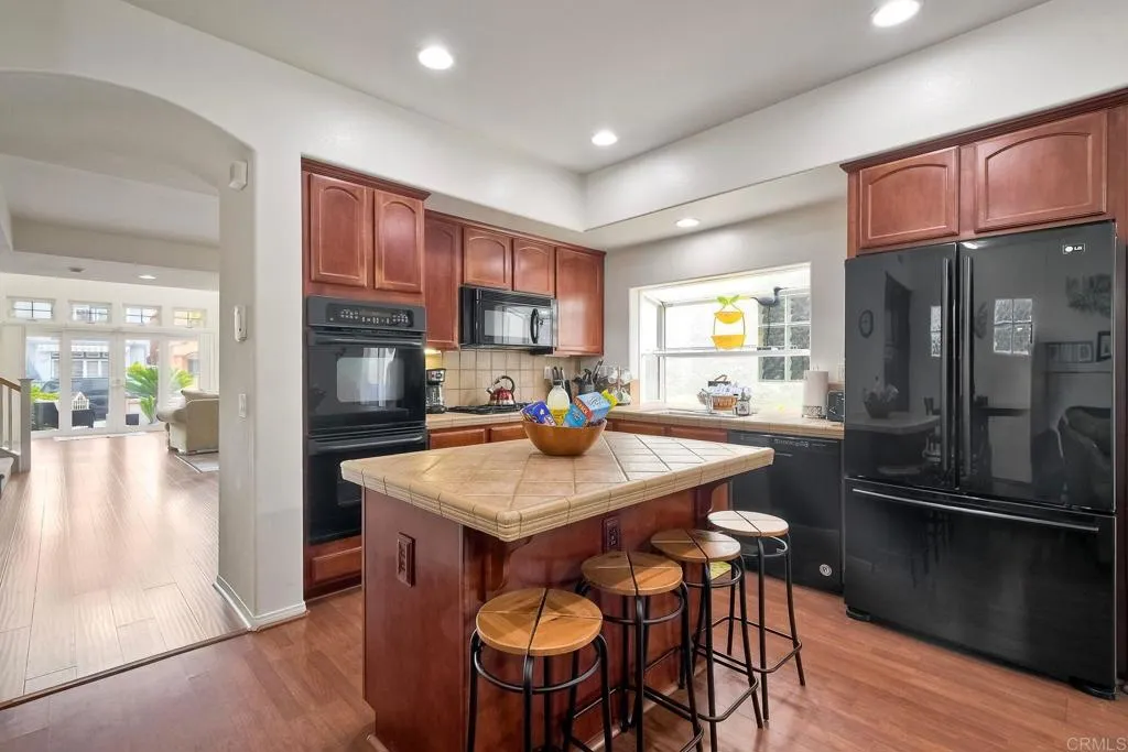 The efficient, well-planned kitchen is fully equipped with dishes, cookware, and all the tools