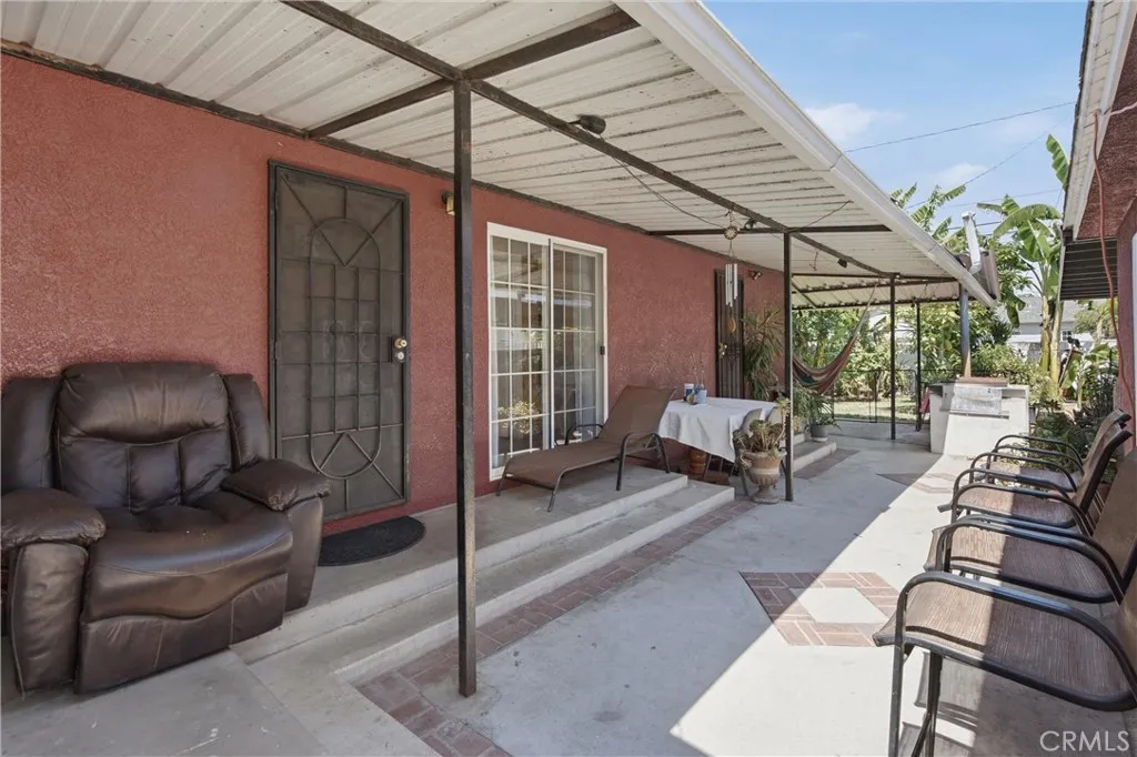 Outside patio cover area between detached garage & the house