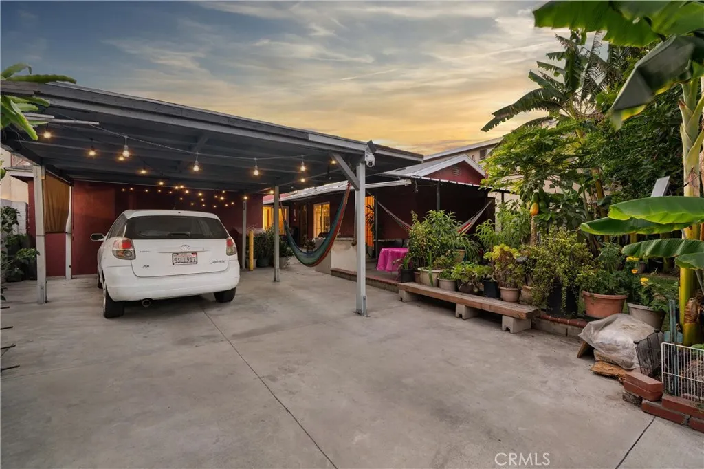Alley entrance with two parking spaces & covered patio
