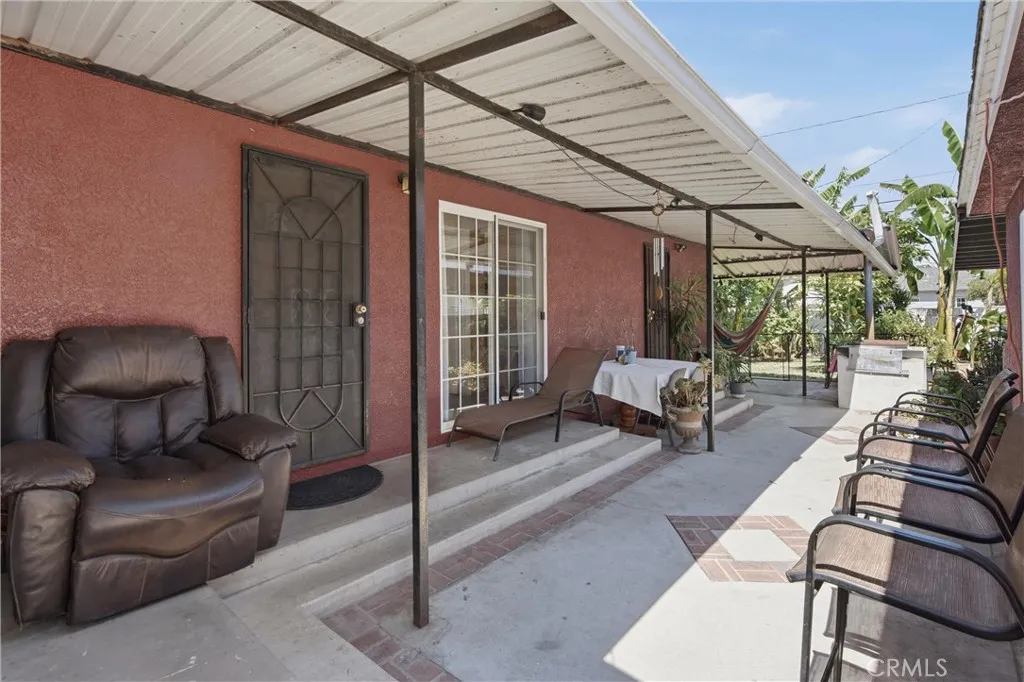 Outside patio cover area between detached garage & the house