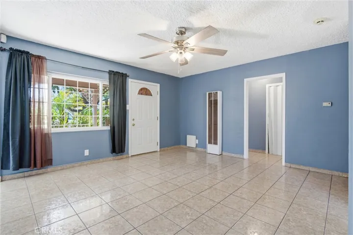 Living Room with tile floor & ceiling fan