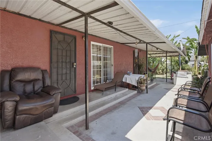 Outside patio cover area between detached garage & the house