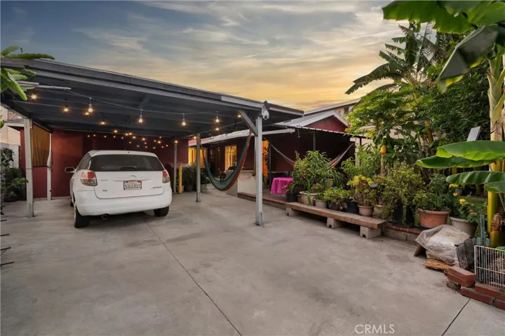 Alley entrance with two parking spaces & covered patio