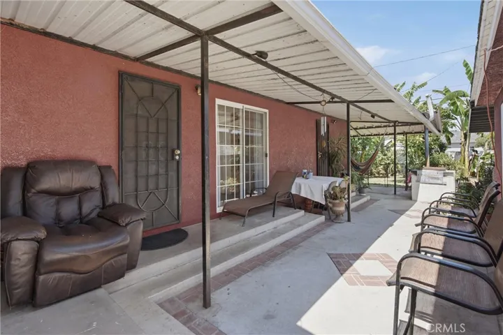 Outside patio cover area between detached garage & the house