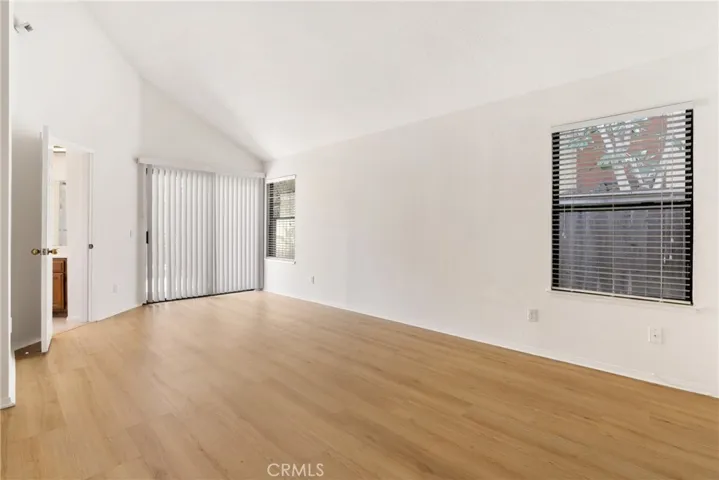 Oversized primary suite with sliding door to backyard and door to bathroom