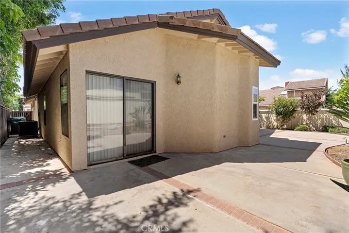 Backyard cement walkway and primary bed sliding door