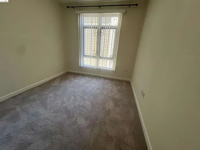 Neutral-toned carpeting paired with light-colored walls
