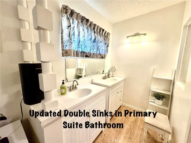 UPDATED DOUBLE SINKS IN PRIMARY SUITE BATHROOM.