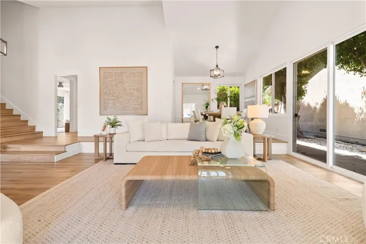 MULTIPLE SETS OF SLIDING DOORS open to the backyard, flooding the interiors with abundant natural light.