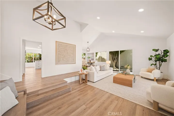 Enter from the custom designed front walkway into the open floor plan with impressive VAULTED CEILING in the living room creating a spacious and airy ambiance.