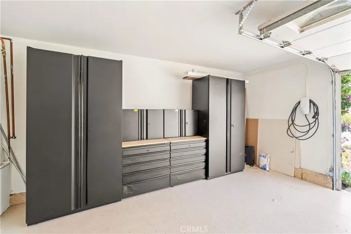 The 2 car garage is equipped with TESLA WALL CHARGER & built-in Husky storage cabinets for added convenience.
