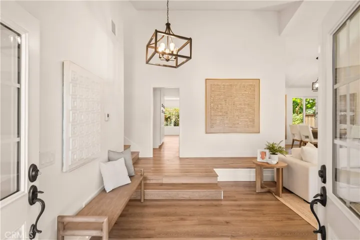 Grand double front doors open to a bright, airy, thoughtfully curated interior.