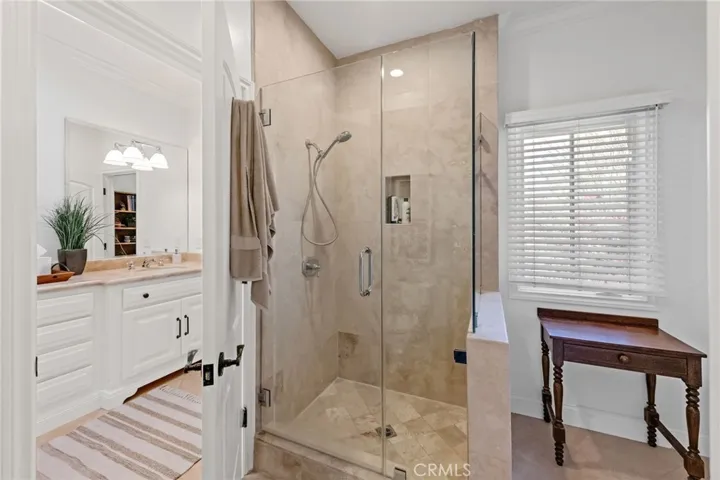 FRAMELESS SHOWER ENCLOSURE IN OVERSIZED WATER CLOSET