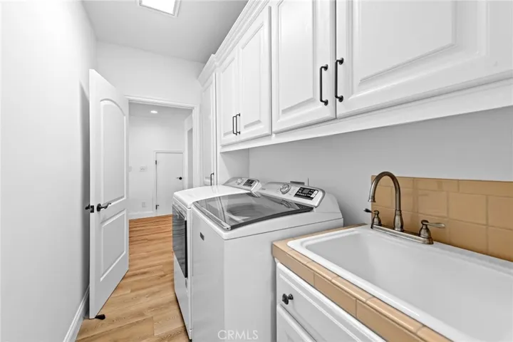 LAUNDRY ROOM WITH SINK AND CABINETRY