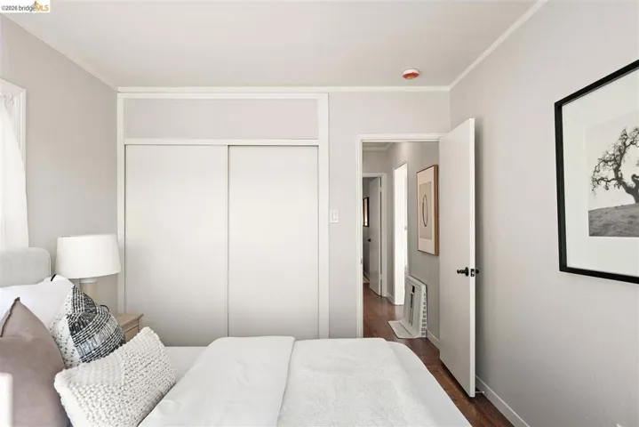 Interior room featuring light-toned walls and wood-finish flooring