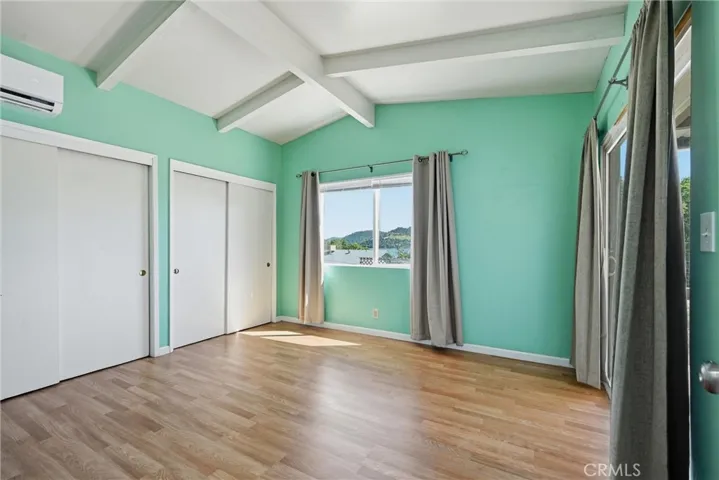 Main bedroom has closet along the entire wall, mini-split, slider opens to the covered patio.