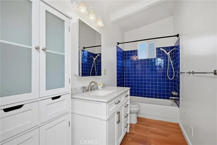 Bathroom has carerra marble countertop, tile shower.