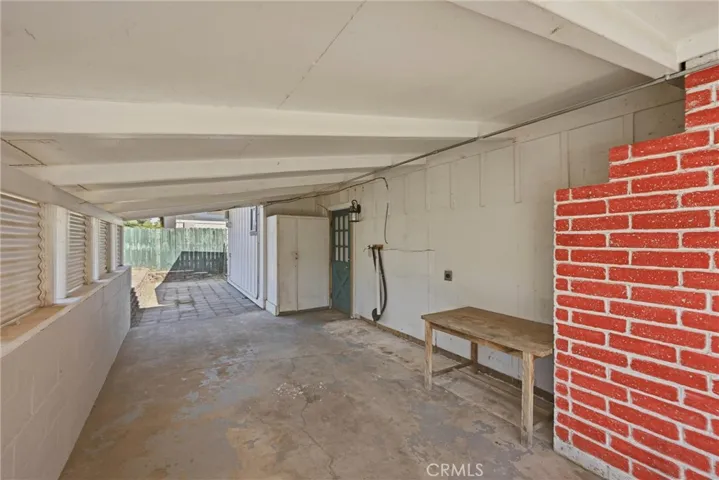 Far side of the carport has pavers for another patio space.