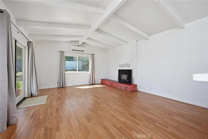 Vaulted ceilings feel spacious; mini-split and fireplace in the living room.
