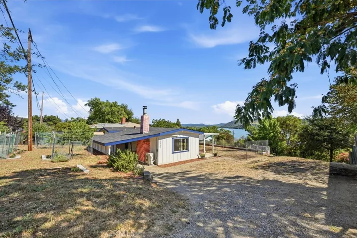 View of the house and front yard with fruit trees.