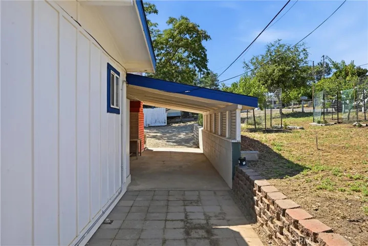 Looking back at the carport from the pavers, fruit trees in the front yard on the right.