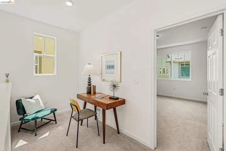 Bright room featuring light gray carpet, white walls, and a recessed ceiling light
