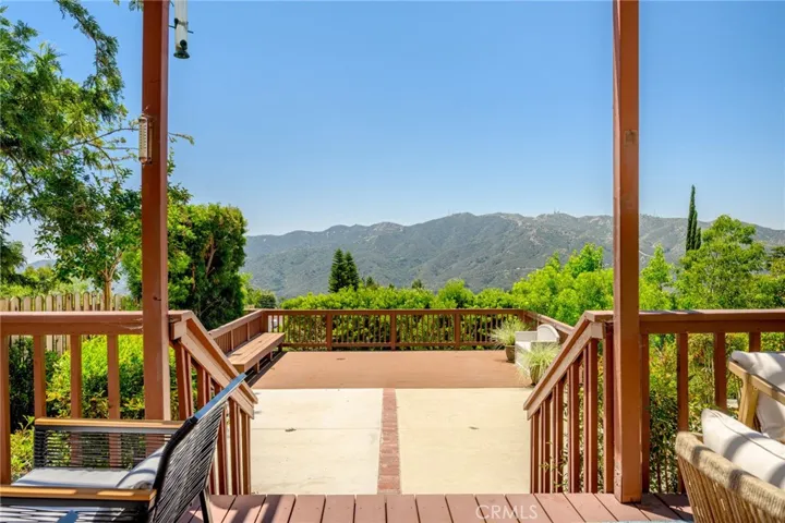 View from top deck to additional patio and deck areas, with beautiful view of mountains