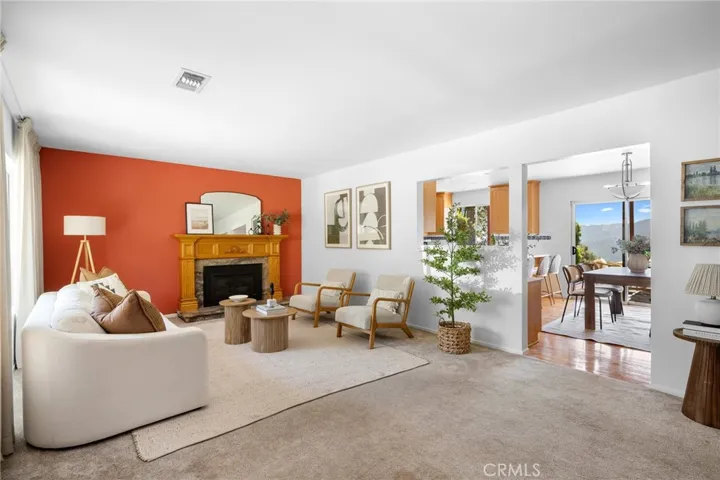 Living room with peek-a-boo into dining room and kitchen, with the beautiful view showing through the glass doors.