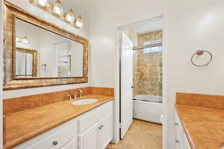 Elegant stone countertops complement the dual-sink vanity.