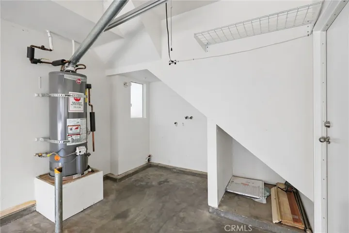 Laundry area located in the attached garage.