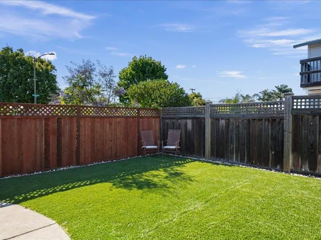 Private patio with a shaded seating area, perfect for relaxing afternoons.