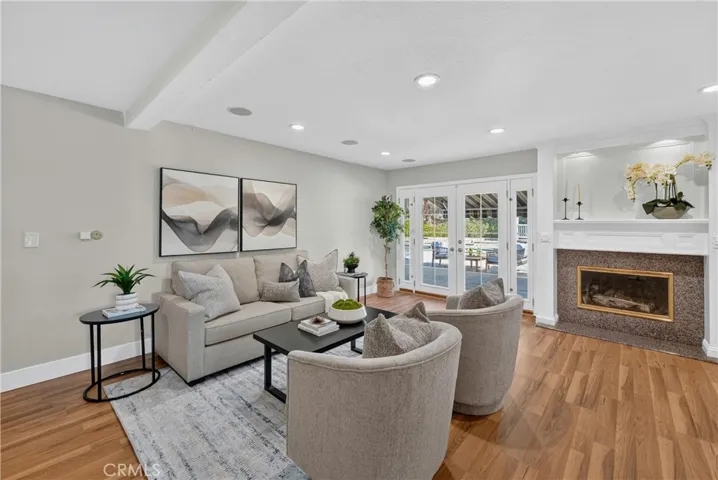 Spacious family room featuring a cozy fireplace and seamless access to the backyard